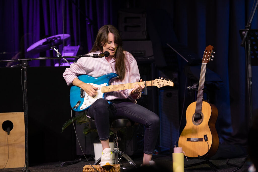 Alyce Chulu playing guitar