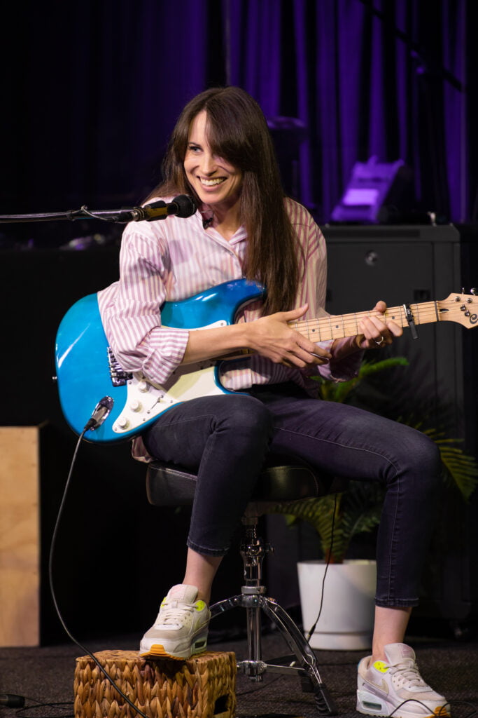 Alyce Chulu playing guitar